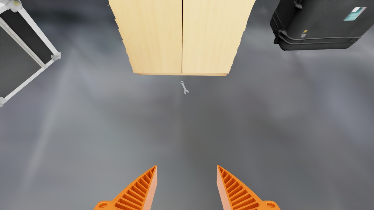 Floor in front of the cabinet with the wrench lying on it.